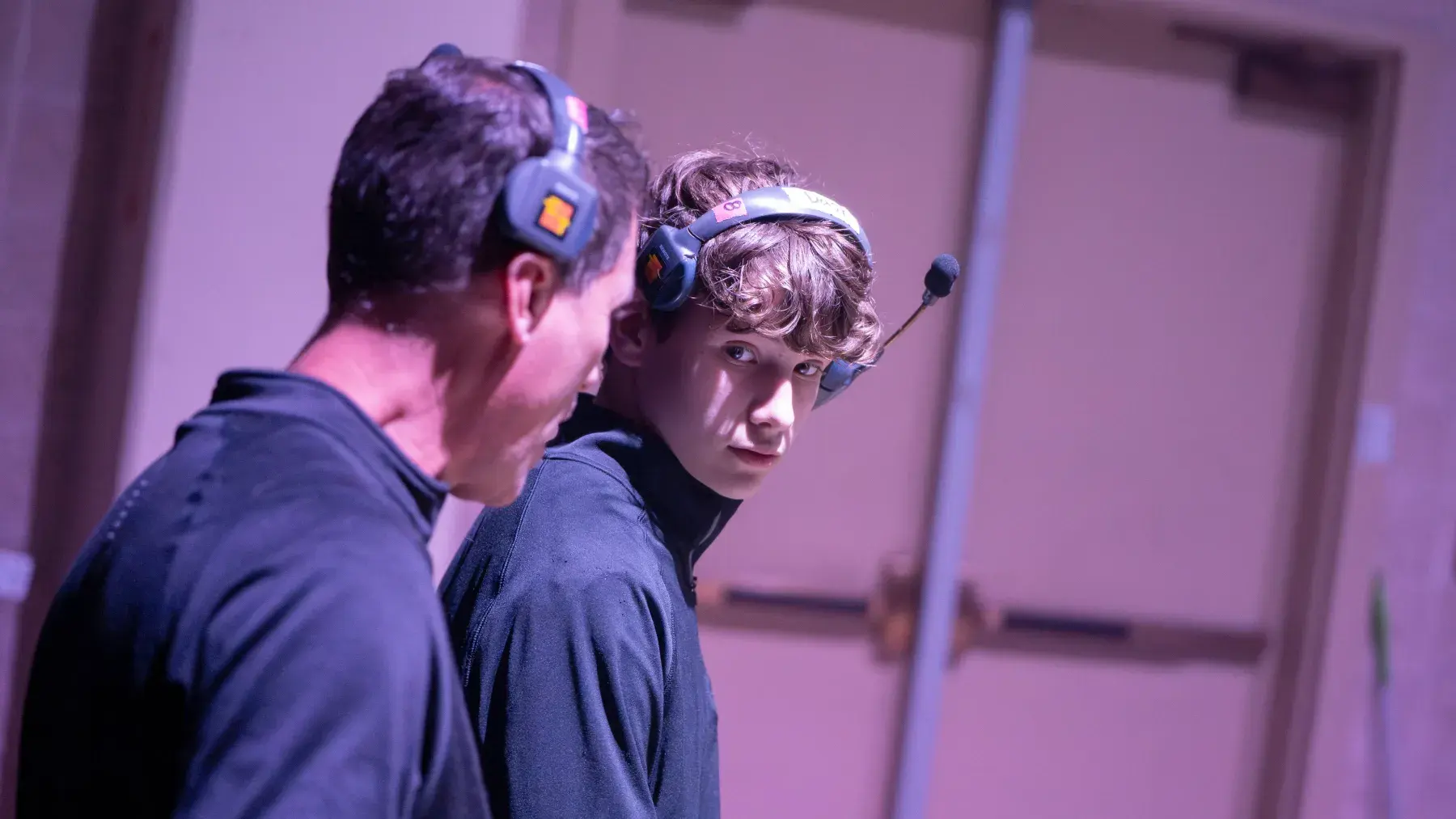 Experienced crew member mentoring a younger teammate