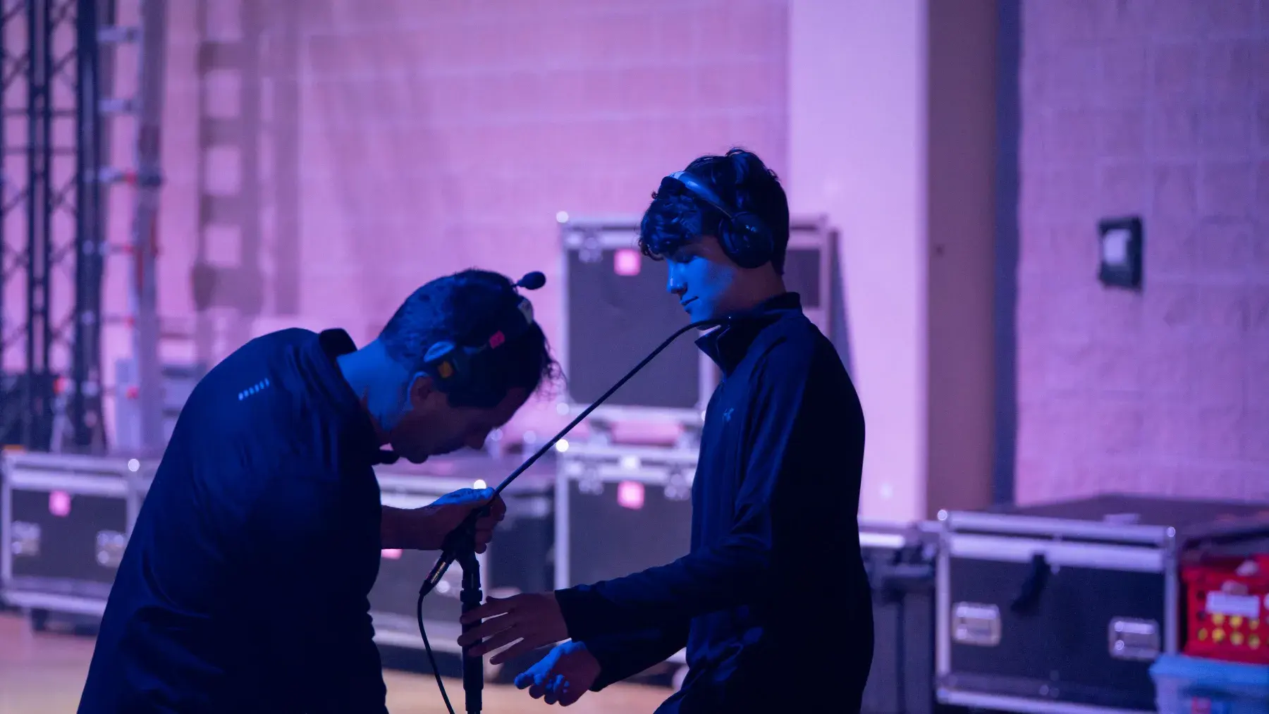 Technicians checking audio equipment backstage