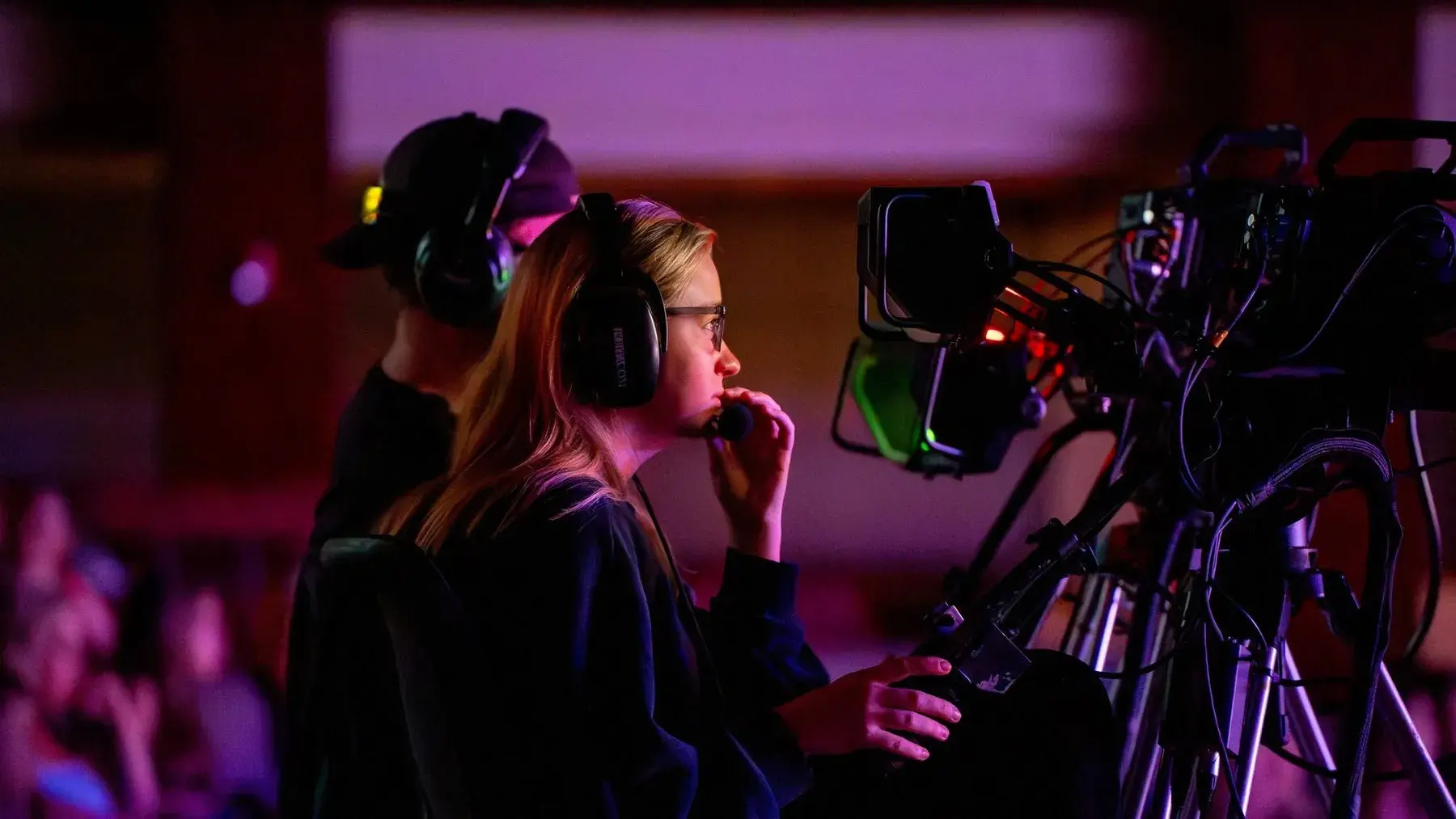 Professional camera operator filming a live event