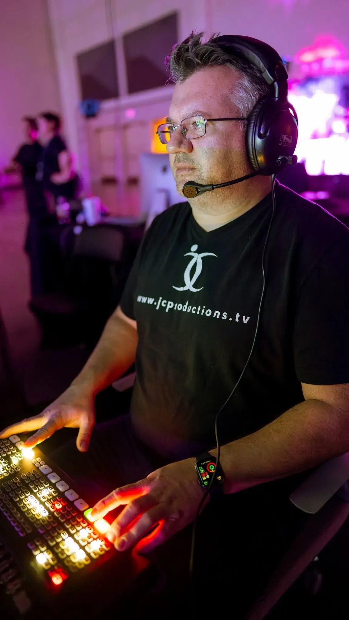 Technical director focused at a production console during a live event