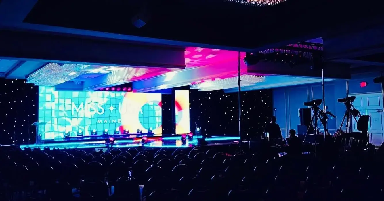Wide event stage with video backdrop and camera platforms