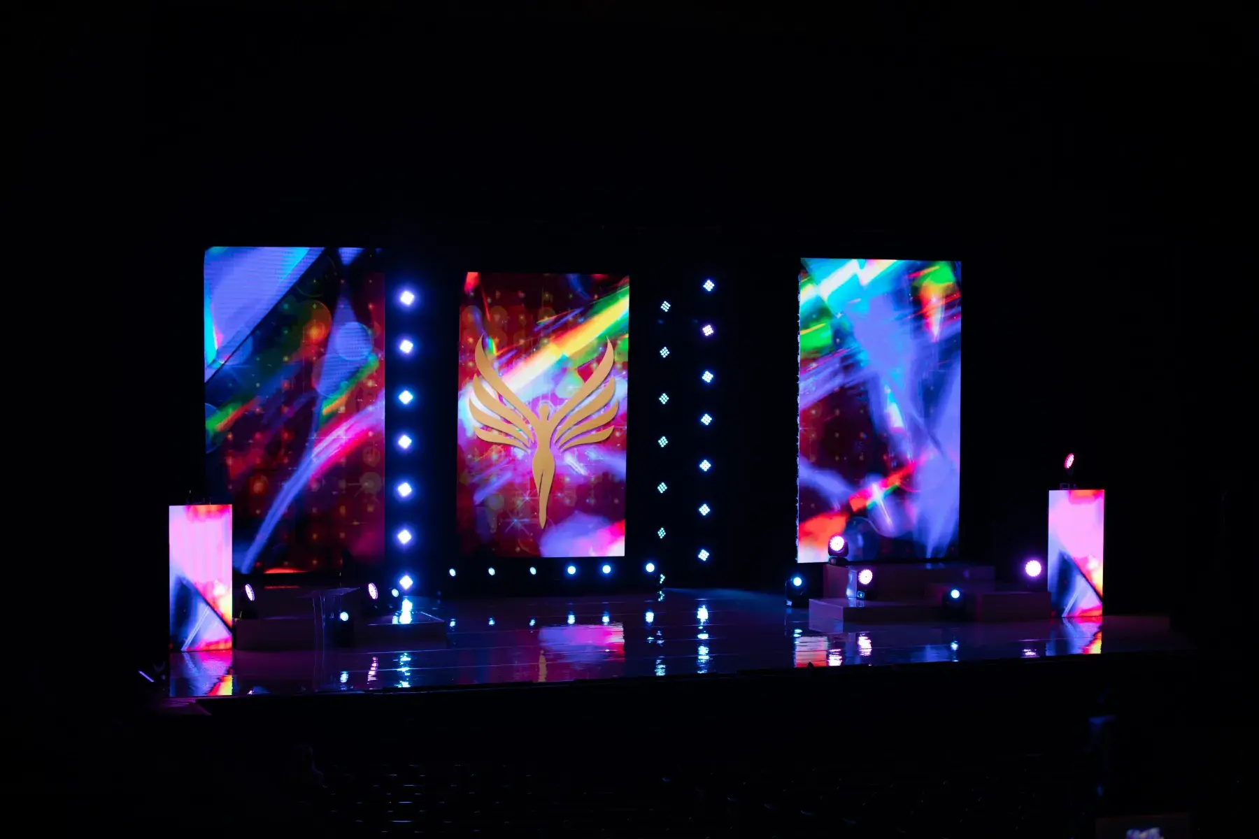 Stage with three vertical video walls and professional lighting